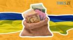 мішок з гривнями на фоні прапору України