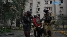 рятувальники несуть постраждало в результаті удару російського дрона по житловому будинку у Києві