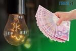 лампочка та рука що тримає гривневі купюри